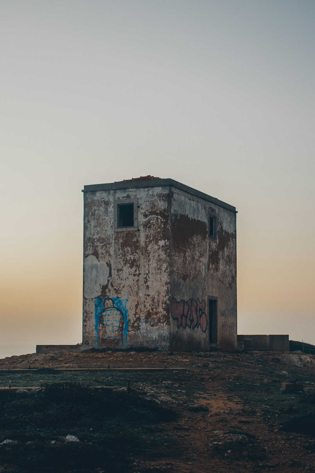 Old iron gate of an abandoned building at dusk