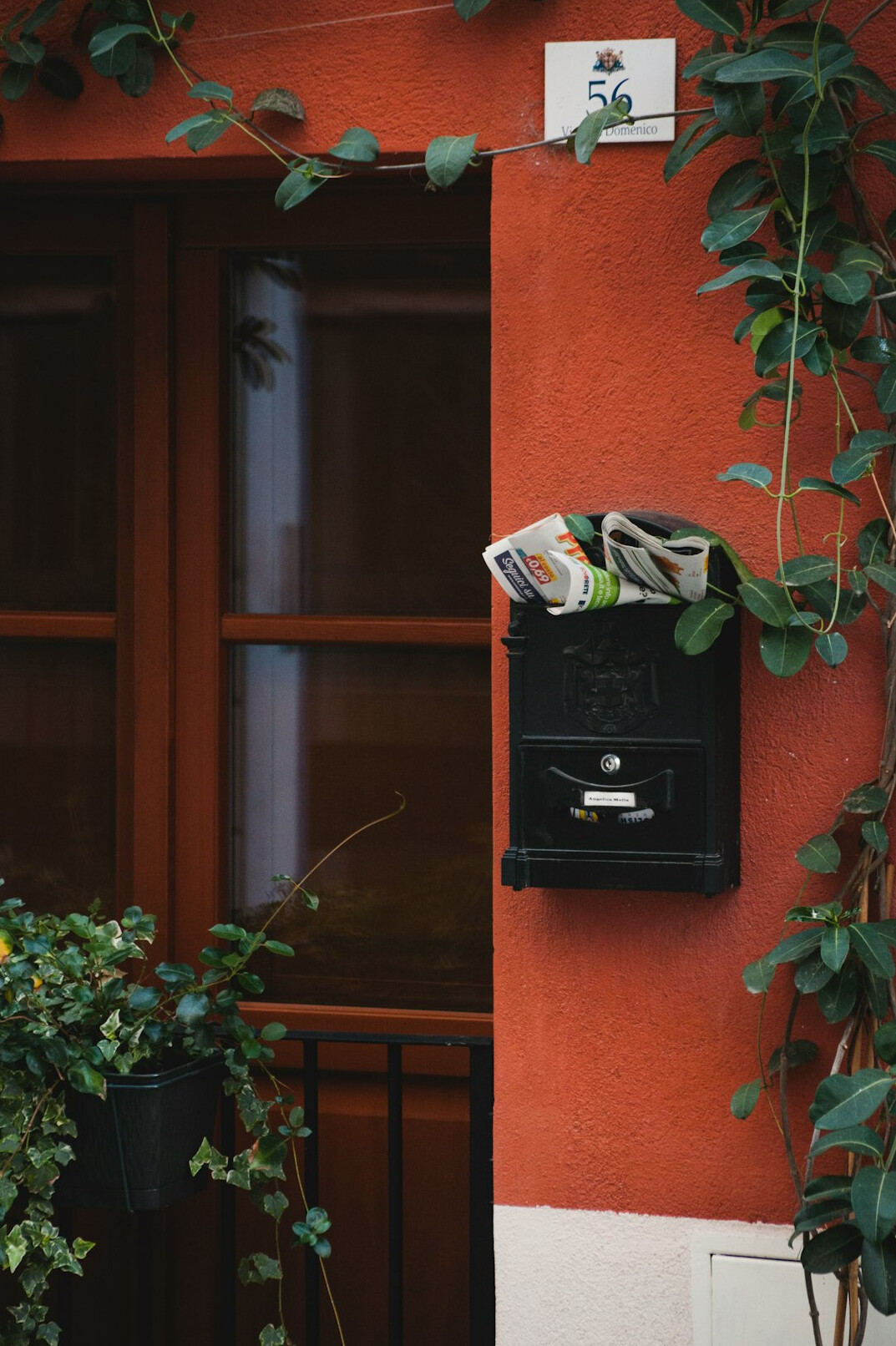 Stack of envelopes beside a vintage mailbox
